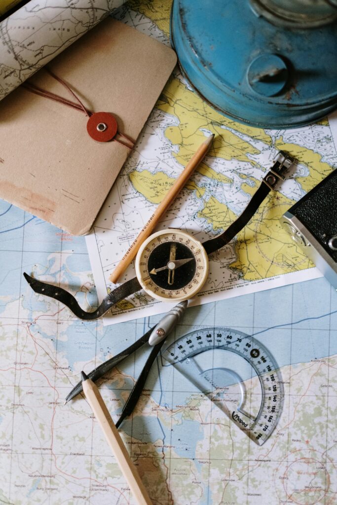 pexels-photo-5370916-5370916 Flat lay of vintage compass, protractor, and maps for navigation study.